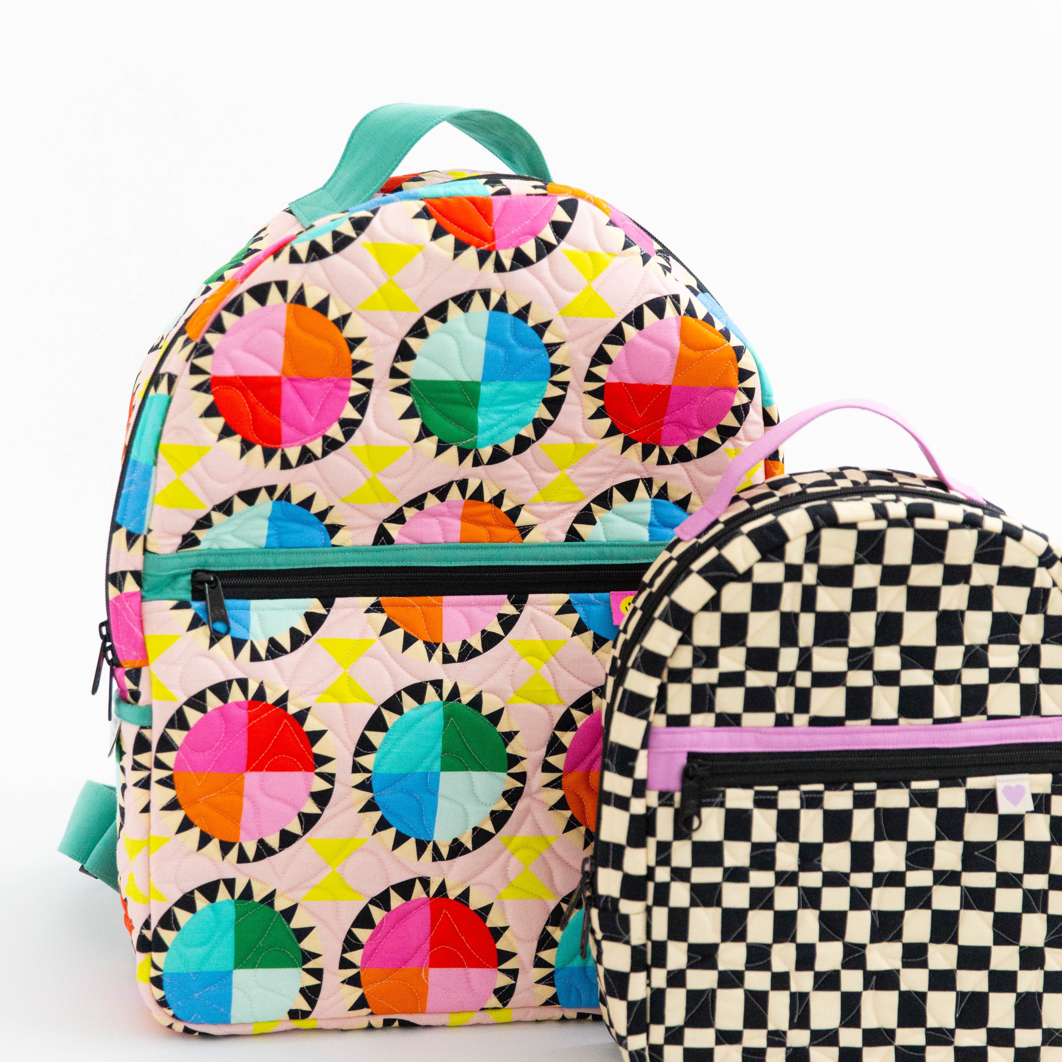 The Archie Backpack (large bag) and the Violet Backpack (small bag)